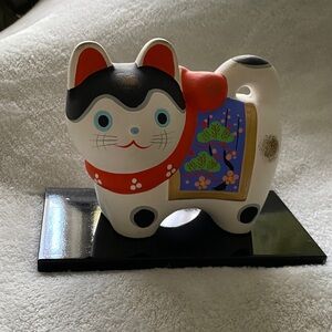Whimsical Cat Figurine with Red and Black Details